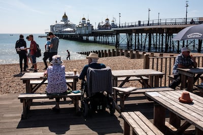 People gather on the beach in front of Eastbourne Pier. Getty Images