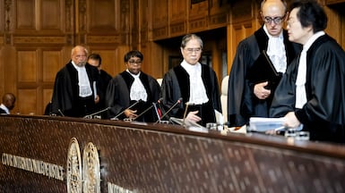 ICJ President Iwasawa Yuji, centre, and other judges arrive for hearings in the case filed by South Africa against Israel. EPA
