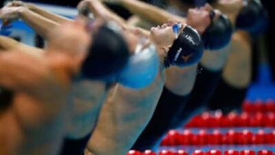Aaron Peirsol, in the centre, broke the world record in the 100m backstroke .