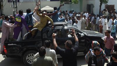 Supporters of former Pakistani prime minister Nawaz Sharif shout slogans outside a polling station as voting takes place in a by-election - won by his wife - in Lahore on September 17, 2017. Arif Ali / AFP