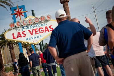 Tourists line up for a photograph in front of the famous Las Vegas sign. Joshua Longmore / The National