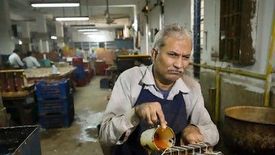 Som Raj,42, though blind makes candles behind the scenes at the bazaar of The Blind Relief Association in New Delhi, India. Simon De Trey-White for The National