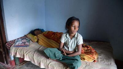 P. Chitti, who lost her father in a road accident, sits at her home. Noah Seelam / AFP