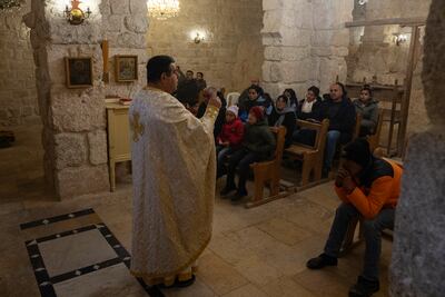 Father Fadi Al Barkil leads a service at the Church of Saints Sergius and Bacchus in Maaloula. Matt Kynaston / The National