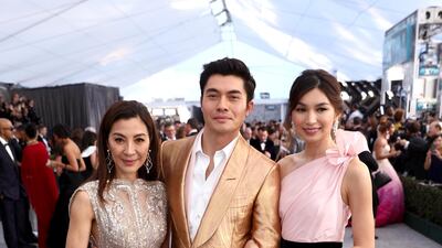 'Crazy Rich Asians' star Michelle Yeoh (far left), wore an Elie Saab gown with a Roger Vivier clutch. Yeoh is seen here with co-stars Henry Golding and Gemma Chan. AP