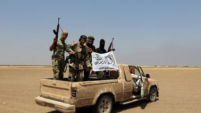 Fighters of the Syrian rebel group Jabhat Fatah Al Sham cheer on a pickup truck after a Russian helicopter was shot down in the north of Syria’s rebel-held Idlib province on August 1, 2016. Ammar Abdullah / Reuters