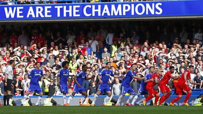 Chelsea and Liverpool players jockey for position as a sign celebrates Chelsea's Premier League title on Sunday. Eddie Keogh / Reuters