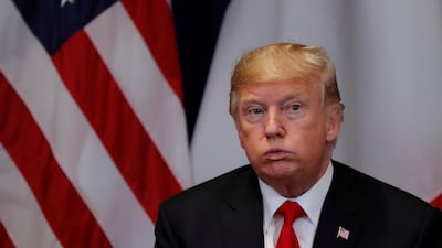 US President Donald Trump reacts during a bilateral meeting with France's President Emmanuel Macron. Reuters