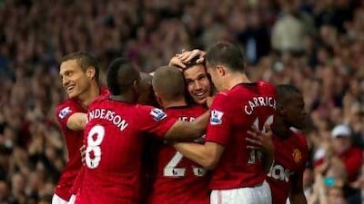 Manchester United's Robin van Persie, centre right, celebrates with teammates after scoring a goal against Fulham. Jon Super / AP Photo