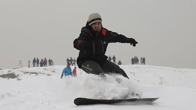 Ahmad Sorush, 22, snowboards on the outskirts of Kabul. AP