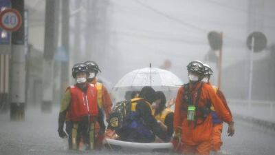 Workers rescue stranded citizens in the Fukuoka Prefecture city of Kurume, south-western Japan, during heavy flooding on August 14. Kyodo News via Getty Images