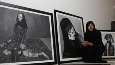 Maisoon al Saleh, 22, at home with her works. "We all end up looking like this," she said.