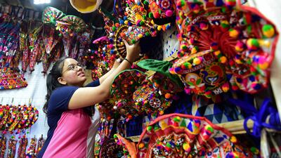 A vendor arranges decorative traditional turbans ahead of the Navratri festival in Ahmedabad. AFP
