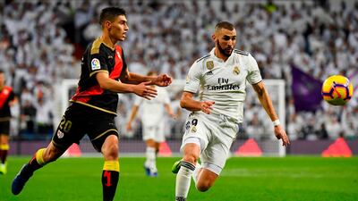 Rayo Vallecano defender Emiliano Velazquez, left, vies with Karim Benzema. AFP