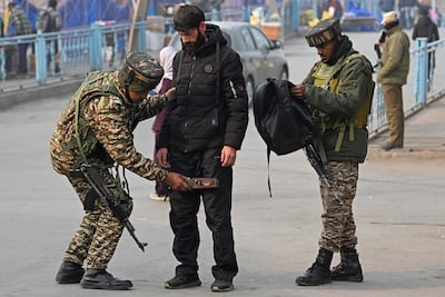 Indian paramilitary troopers frisk a pedestrian in Srinagar, Kashmir, with security heightened since the car bombing in New Delhi. AFP