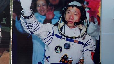 A photo from 2012 showing Chinese astronauts from Liu Yang, Jing Haipeng and Liu Wang as they wave before a giant portrait of China's first astronaut Yang Liwei, as they depart for the Shenzhou 9 spacecraft rocket launch pad at the Jiuquan Satellite Launch Center in Jiuquan, China. File photo / AP Photo.