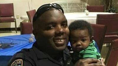 Baton Rouge Police Officer Montrell Jackson holds his son Mason at a Father’s Day event for police officers in Baton Rouge. Jackson and two other Baton Rouge law enforcement officers investigating a report of a man with an assault rifle were killed Sunday. Courtesy of Trenisha Jackson via AP