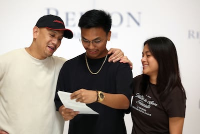 Johann Nicholas Francisco, centre, in celebratory mood. He will go on to study at the University of Woolongong in Dubai. Chris Whiteoak / The National