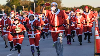 More than 800 runners dressed as Santa Claus braved near-freezing temperatures to participate in the Run Run Santa 1 Mile on Christmas Eve. Florida Today / AP