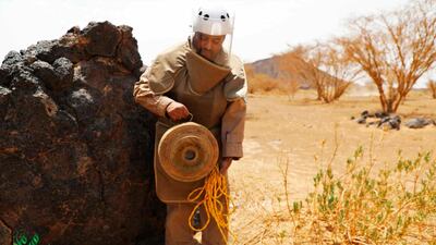 A bomb disposal officer holds a deactivated mine near Marib, Yemen. Wam