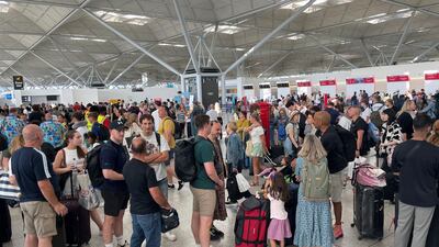 Passengers queue at London Stansted Airport, as a global computer systems breakdown affects airlines, broadcasters and banks. AP