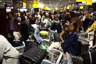 Delayed passengers queue with their luggage at Terminal 3 of London Heathrow airport. AFP