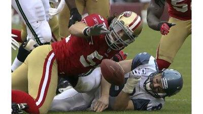 Seattle Seahawks quarterback Matt Hasselbeck is tackled by 49ers linebacker Travis LaBoy.