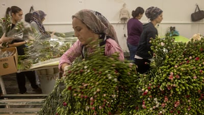 All the hard work is to make sure the flowers arrive in time for Monday's funeral. Getty