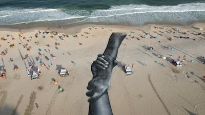 A land-art fresco made with biodegradable paint consisting of charcoal, chalk, water and milk proteins by French-Swiss artist Saype, covers Copacabana beach in Rio de Janeiro, Brazil. The work is part of the artist's worldwide project, 'Beyond Walls'. AP Photo