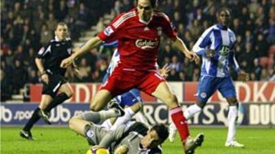 Yossi Benayoun, centre, scores the goal for Liverpool but Mido equalised for Wigan from the penalty spot.