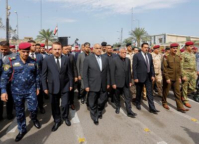 Iraqi Prime Minister Adel Abdul Mahdi, third left, walks to the right of Hadi Al Amri at the funeral ceremony for a slain police commander on October 23, 2019. Reuters