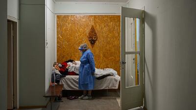 Margaret Melnic, 67, the chief of Covid-19 section of the hospital, talks with a woman suspected woman to have the coronavirus in the hall of regional hospital in Leova city, Moldova. AFP