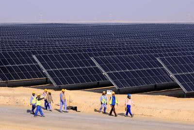 Employees at a solar power plant in Al Dhafra, Abu Dhabi on January 31. It is not hyperbole to suggest the technologies at the heart of green finance will change, or even save, the world. AFP