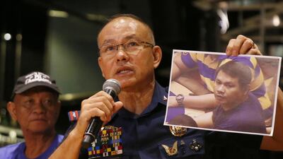 Manila police chief Oscar Albayalde shows a photo of Jessie Carlos, the gunman who stormed the Resorts World Manila complex on Friday, killing 37 people. Bullit Marquez / AP Photo