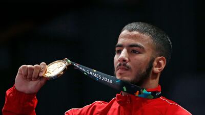Hamed Nawad proudly displays his gold medal, one of three won by the UAE in the Asian Games so far. Reuters