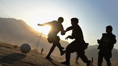 Children play football in a field in Kabul. November 23, 2014. Shah Marai / AFP