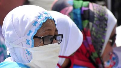 A pilgrim wears a nose and mouth mask in Mecca. Facilities for cleanliness in the holy city were found wanting, some said. AFP