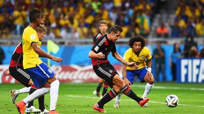 Germany’s Miroslav Klose, second right, scores his team’s second goal in a lop-sided semi-final win over Brazil on Tuesday. Laurence Griffiths / Getty Images