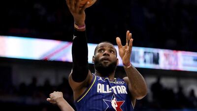 LeBron James attempts a layup past Khris Middleton. AFP