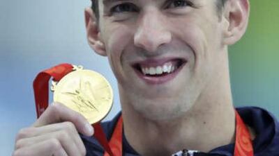 Michael Phelps celebrates with his gold medal after winning the 400m individual medley final.