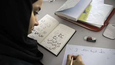 A student practices her writing at an Arabic typography workshop in Dubai. Jaime Puebla / The National