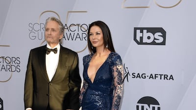 Catherine Zeta-Jones wore a Zuhair Murad dress with Christian Louboutin shoes, Chopard jewellery and a Jimmy Choo clutch. Zeta-Jones is seen here with husband, Michael Douglas. AFP