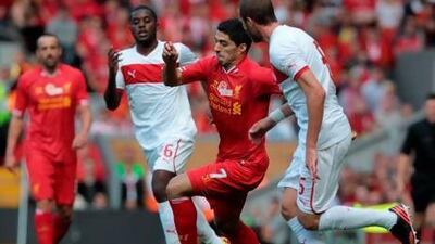 Luis Suarez, centre, was introduced as a second-half substitute by Brendan Rodgers in Liverpool's 2-0 win over Olympiacos. Lindsey Parnaby / AFP