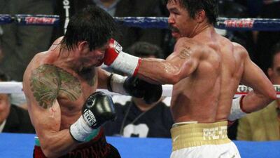 Antonio Margarito is hit with a left by Manny Pacquiao in the 5th round of their 12-round WBC World Super Welterweight title boxing fight in Arlington, Texas, on November 13, 2010. Pacquiao eventually cemented his place in the pantheon of boxing greats by recording an unanimous points victory over Margarito on Saturday to claim the vacant WBC super welterweight title. REUTERS/Tim Sharp