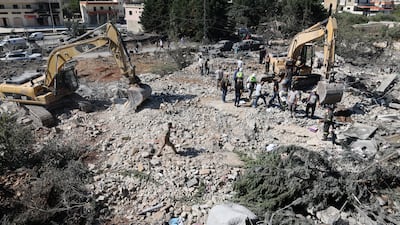 Rescue teams use mechanical diggers to search the rubble of a building hit by an Israeli air strike in Kfar Roummane, southern Lebanon. EPA