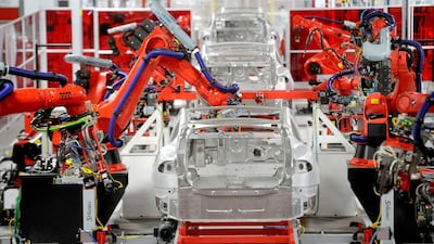 Robotic arms assemble Teslas at the company's factory in Fremont, California. Noah Berger / Reuters