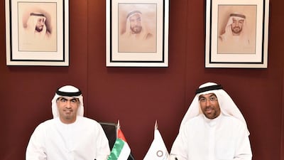 Hamad Abdullah Al Shamsi, left, the chairman of Abu Dhabi Securities Exchange, and Ahmed Al Sayegh, the chairman of Abu Dhabi Global Market during the signing of memorandum of understanding between the two bodies. Courtesy photo