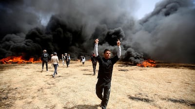 Palestinian protesters burn tyres during clashes with Israeli troops. Adel Hana / AP Photo