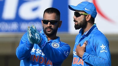 Virat Kohli, right, has taken over from MS Dhoni, left, as India's limited overs captain. Sajjad Hussain / AFP