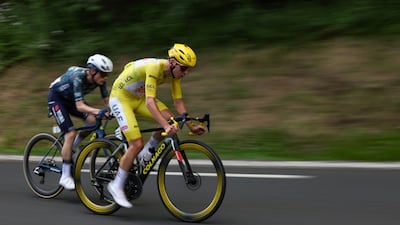 UAE Team Emirates rider Tadej Pogacar ahead of Jonas Vingegaard of Team Visma-Lease a Bike in a lead breakaway in the final kilometers of Stage 11. AFP